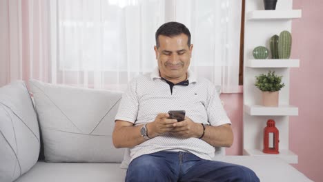 Man-texting-with-happy-expression.